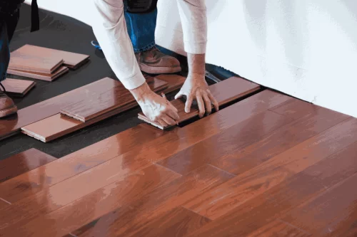 A worker installing a waterproof and scratchproof flooring hardwood.