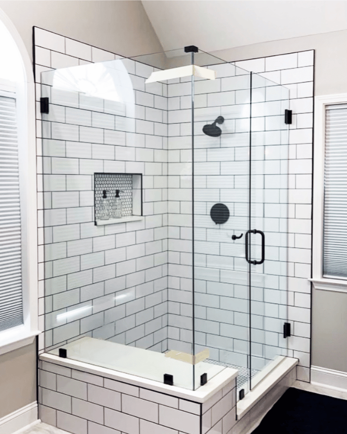 A beautiful shower with white tiles and white flooring