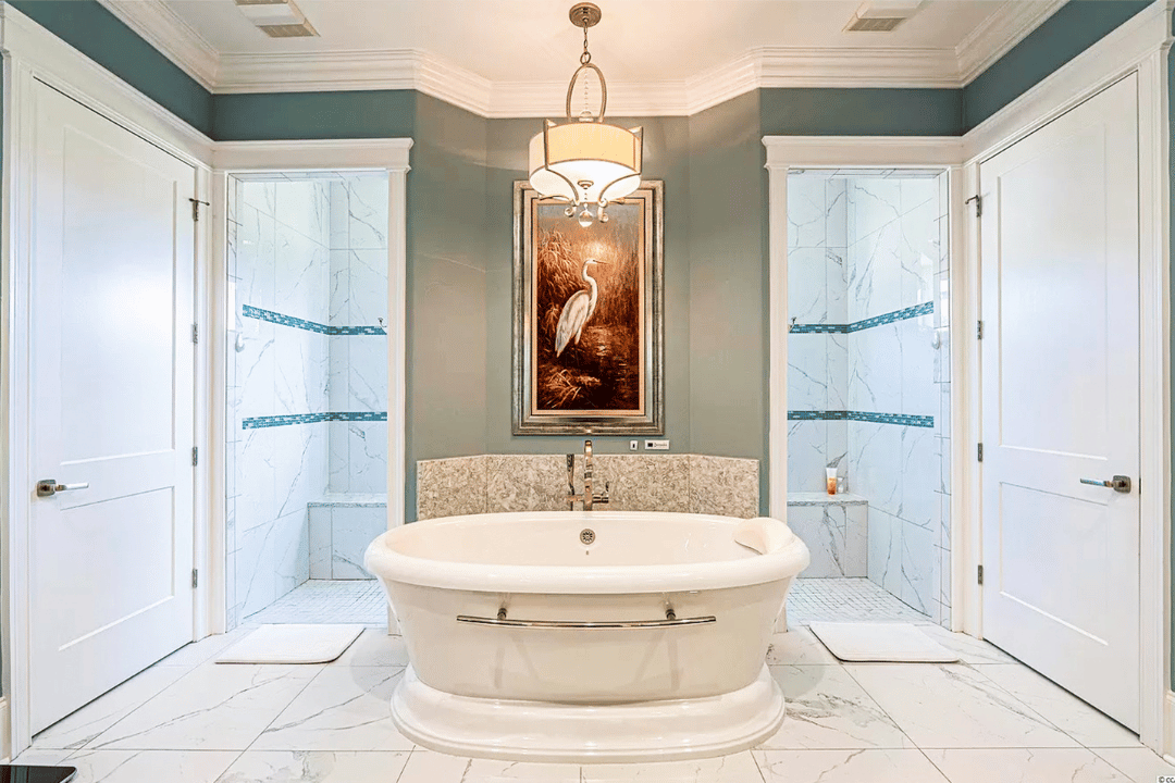 A beautiful tub in the middle of white tile flooring of a bathroom.